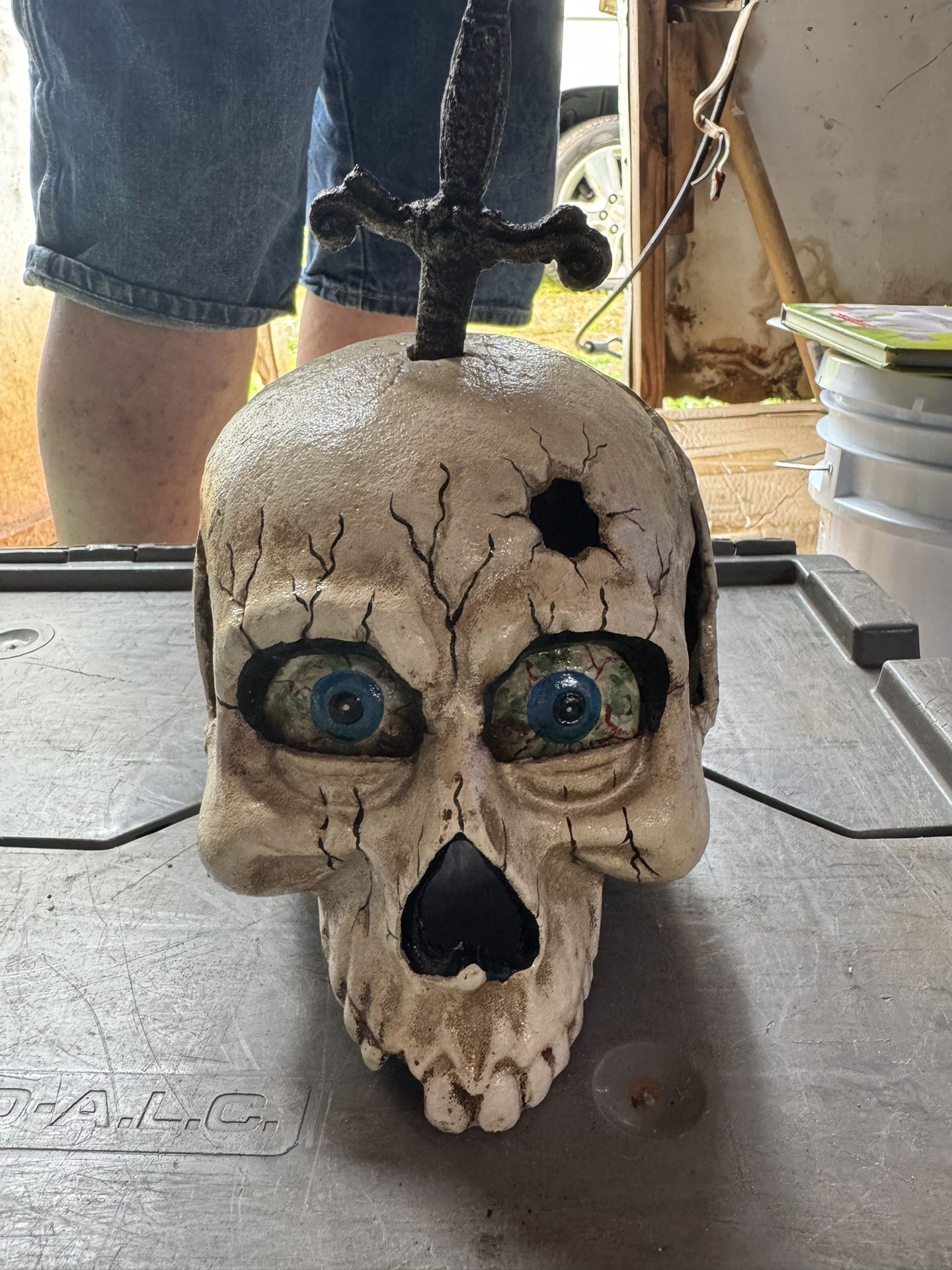 Haunted Skull Prop w/ Sword – Creepy Halloween Horror Decor – Blue Eyes