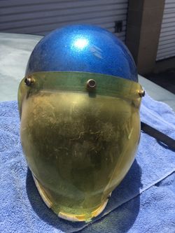 Vintage open face motorcycle helmet with bubble visor.