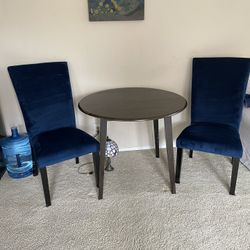 Circle Bistro Table and Two Blue Suede Chairs