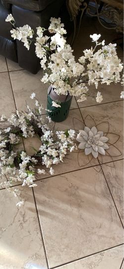 Door wreath and artificial flowers with vase