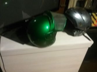 Two motorcycle helmets one modular one custom green candy