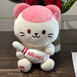Anirollz pink/white cat plush holding a round 1 blowing pin