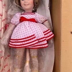 Danbury Mint Shirley Temple porcelain doll, specifically the "Bright Eyes" edition or the "Stand Up and Cheer" 