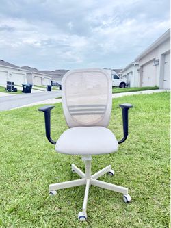 Selling a cream-colored office chair with armrests.