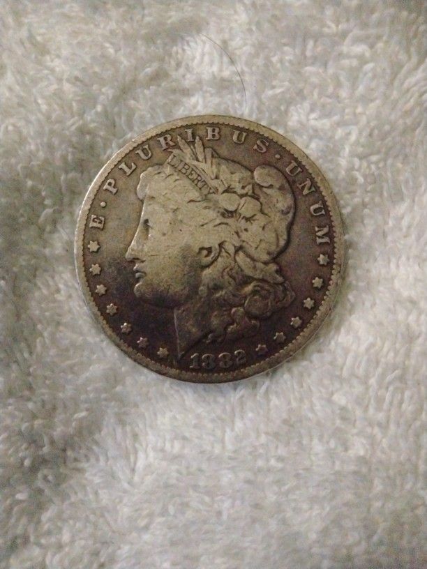 1882 and a 1921 Morgan Silver Dollar