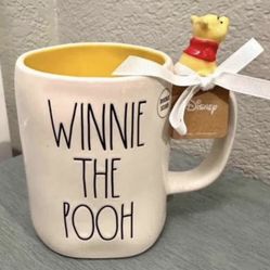 $15 each..  New Rae Dunn  Disney Winnie-the-Pooh collection -  mug.  Adorable Winnie the Pooh mug. White mug has a bright yellow inside. 'WINNIE THE P