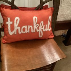 Orange pillow with 'thankful' embroidery 20” x 30”