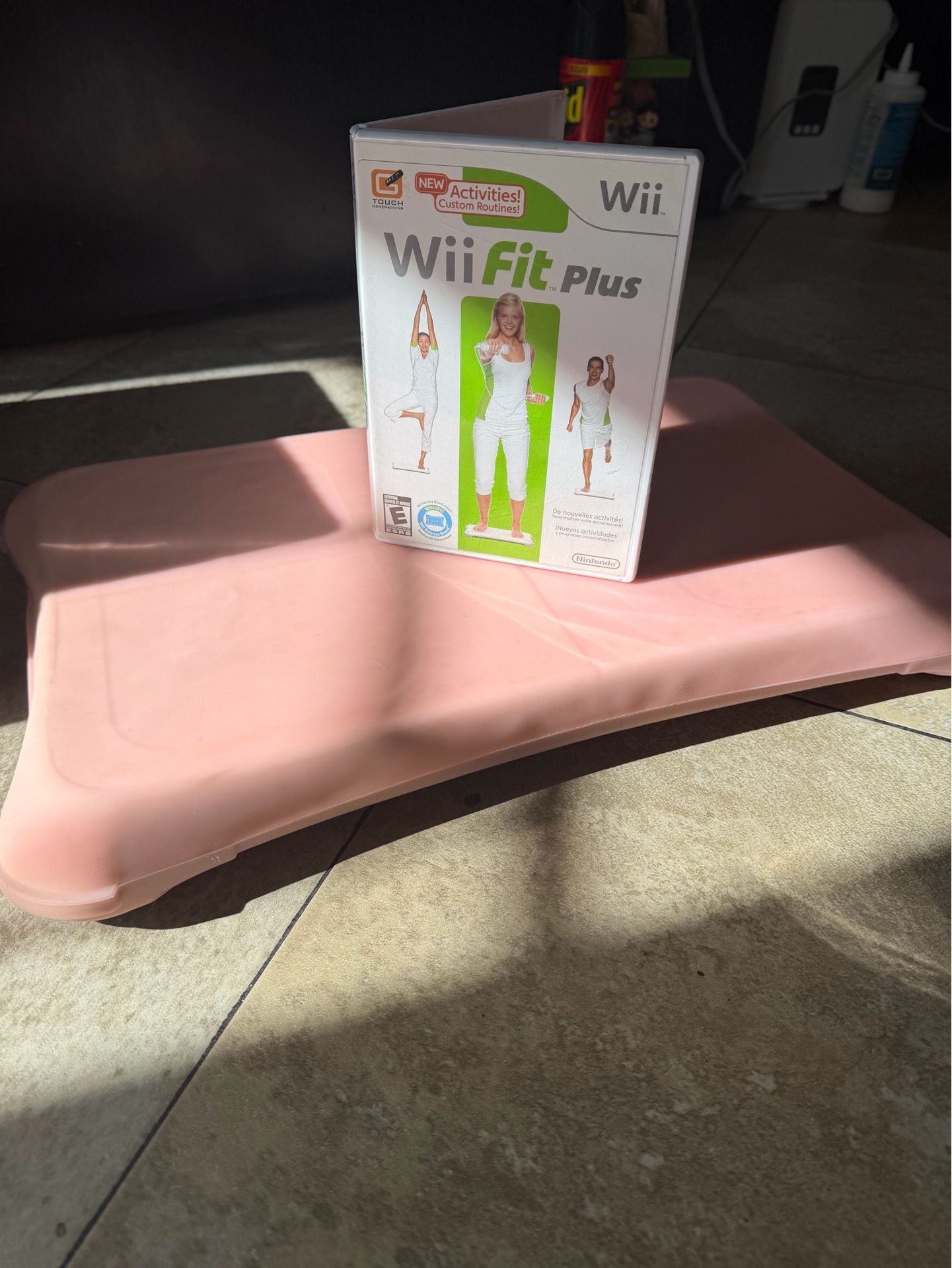 Nintendo Wii Fit Plus game with pink Wii Balance Board