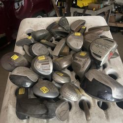 Assortment Of Golf Clubs And Drivers