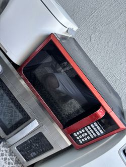 red Hamilton Beach countertop microwave oven.