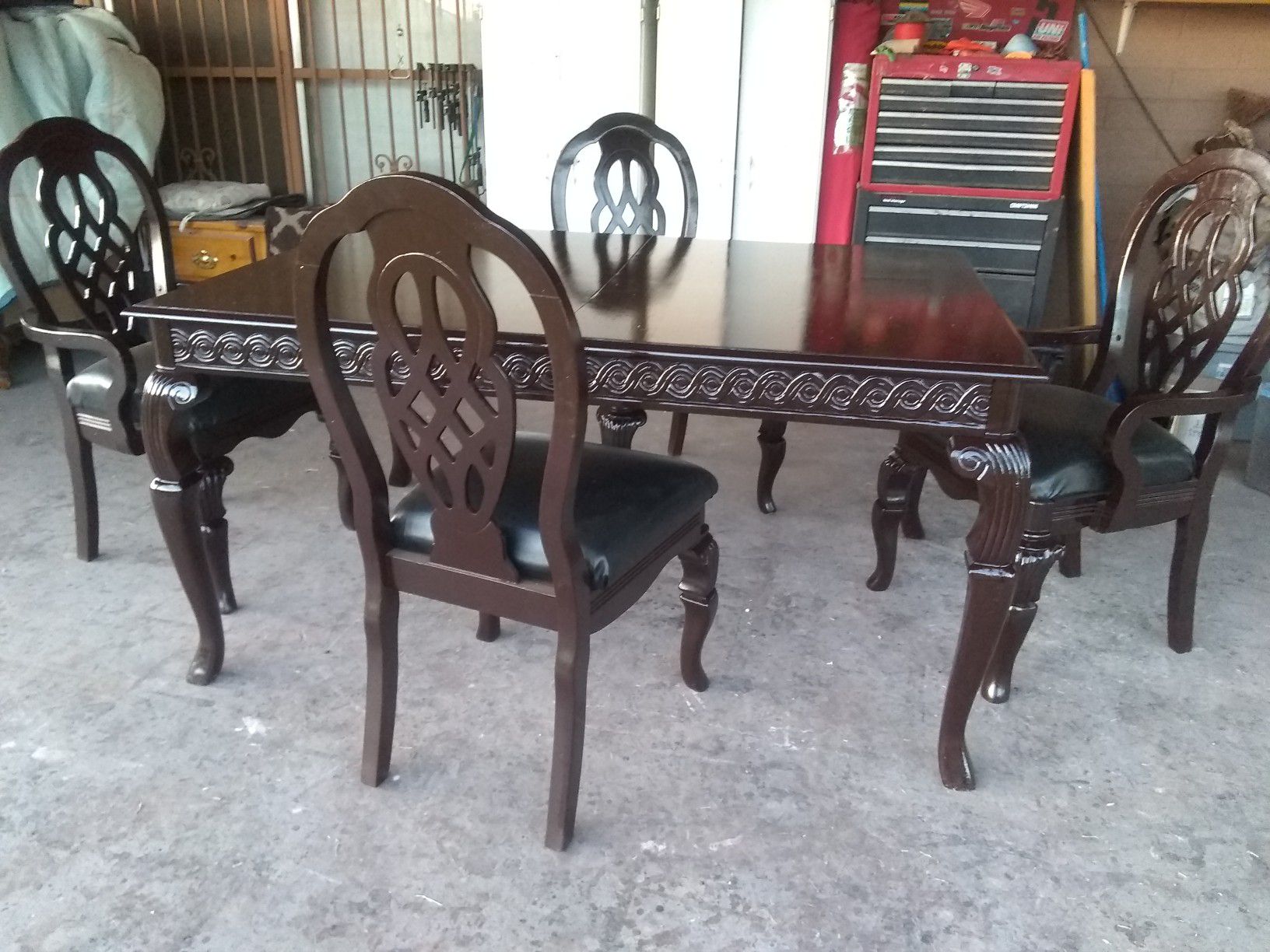 Black cherry dining table with,4 matching chairs,1 leaf ,2 Capt 2 regular , Black leather seats