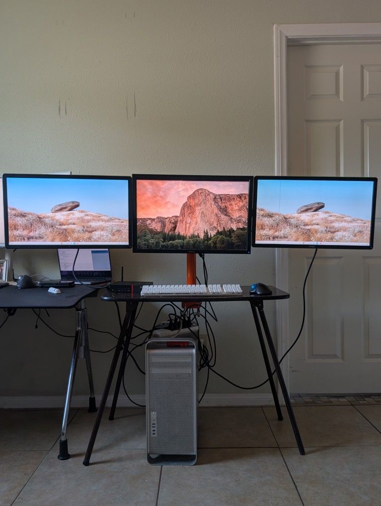 Theee Dell Monitors and Floating DeskMount.