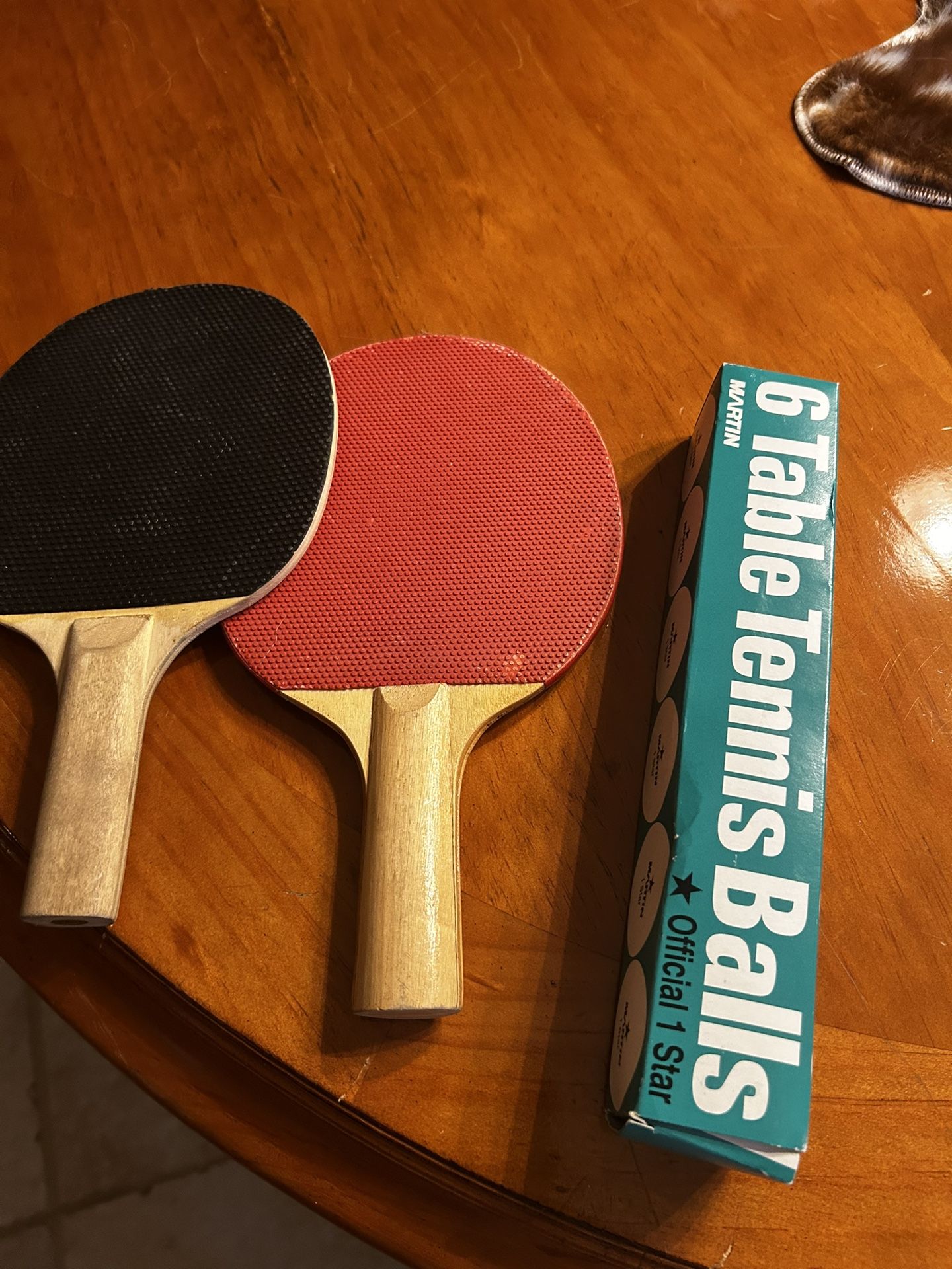 Two ping-pong paddles and balls