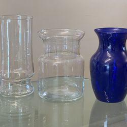 3 Glass Flower Vases Two Clear Vases And One Blue Vase