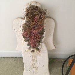Wooden angel with dried flowers