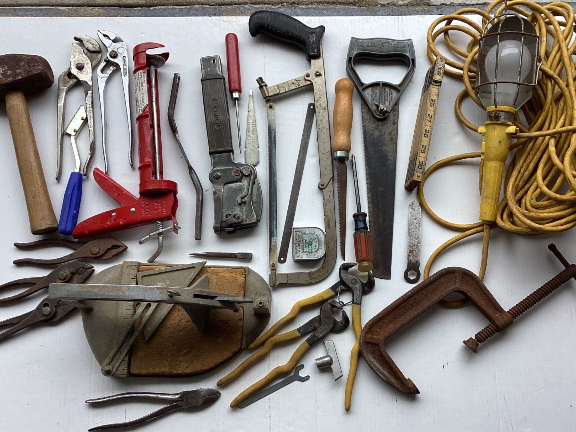 Vtg. 25+ Assorted Tools, C-clamp,Pliers, Caulking Gun, Tile Snips,Tile Cutter,Foldout Wood Ruler,Mallet,Saws,Shop Metal Cage Lamp etc. Preowned
