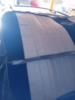 1957 to 1959 maybe others front seat covers bench style black and gray with Chevy emblem on back top cover nice  and brand new front carpet brown trim
