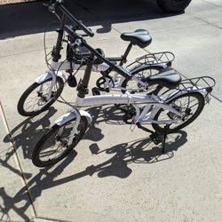 Two Folding Bicycles One With Child Seat