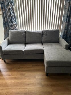 Living Spaces Stark Grey sofa with reversible chaise and Stark Grey swivel chair