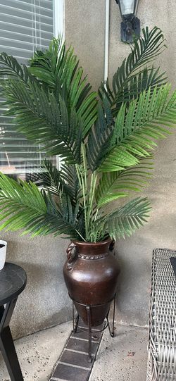 Large artificial palm plant with decorative pot