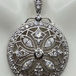Sterling Silver (925) pendant featuring an intricate filigree design with sparkling cubic zirconia stones. Marked “925” and “FAS,”