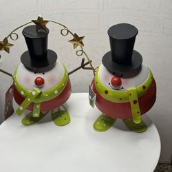 This is a set of two decorative metal snowmen.