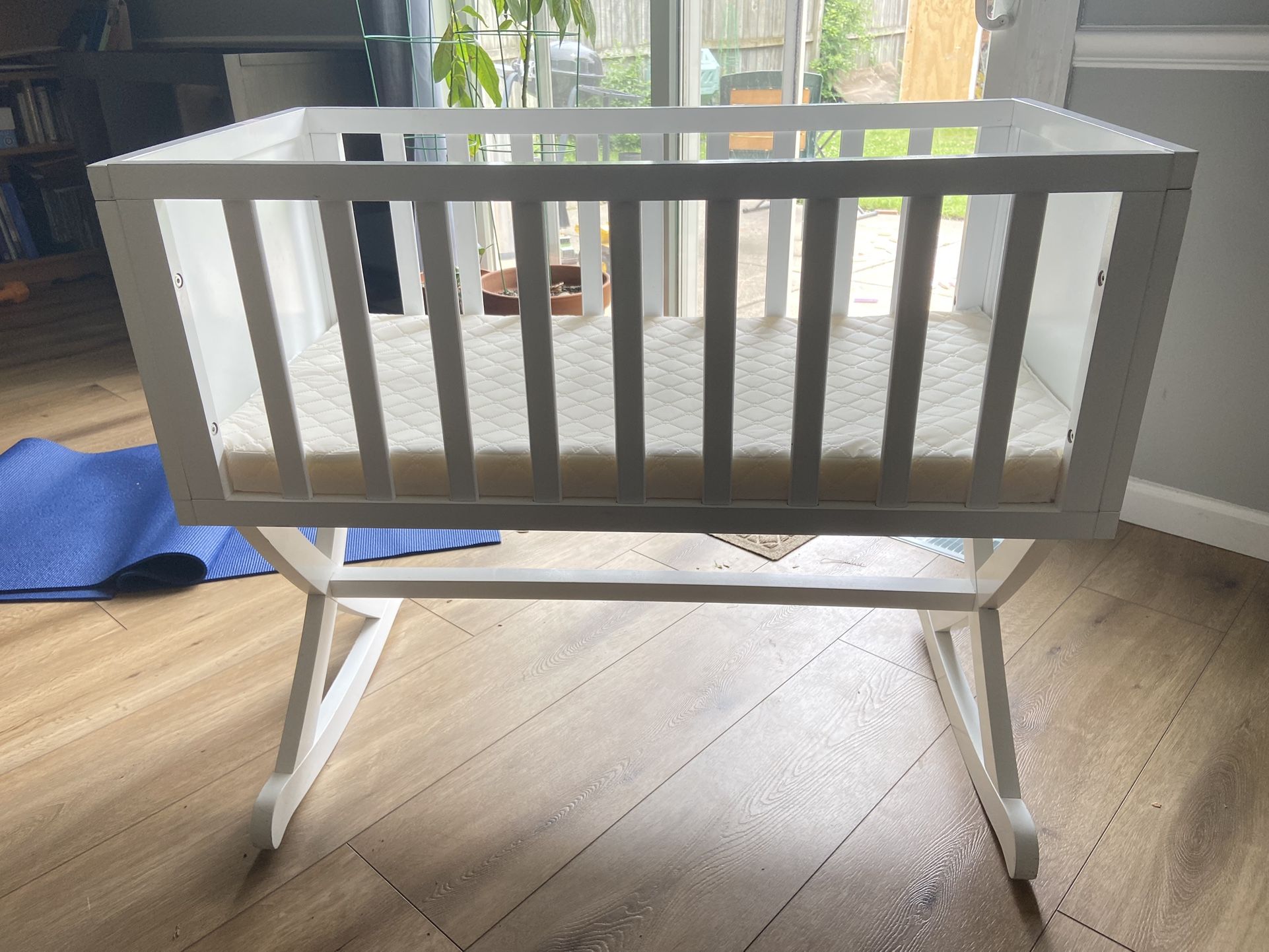 White wooden rocking bassinet