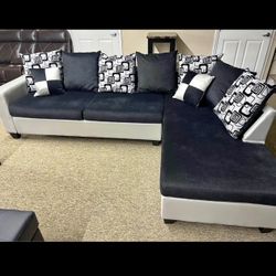 New black and silver L-shaped sectional sofa with pillows
