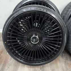 New 24 inch gloss black wheels with floating Range Rover caps wrapped in Lexani 295/30r24 tires