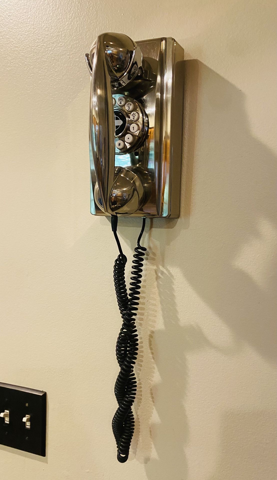 Crosley,Wall Phone, in a brushed chrome finish.