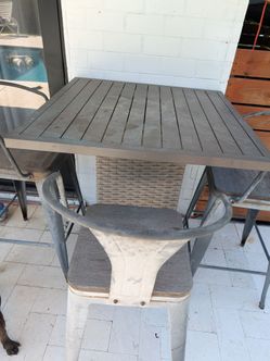Tall patio bar table and 3 chairs
