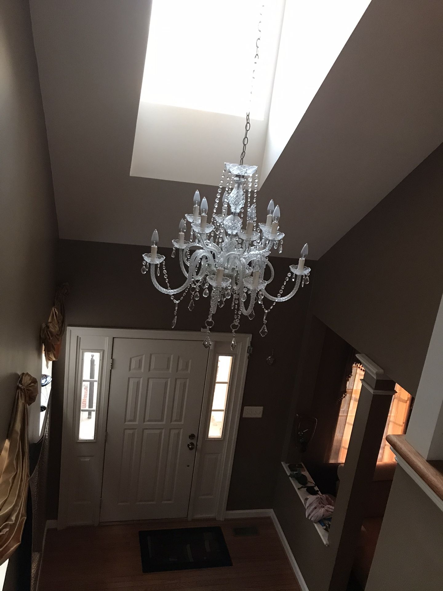 Crystal chandelier with adjustable cable can be hanged in the foyer, dining room, living room. Dimensions: 30’H. 33’W Used like new