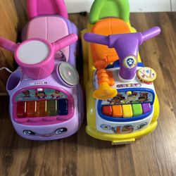 Set of 2 VTech ride-on toys with interactive features.