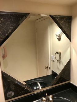 Beveled octagon mirror with Black and Tan marble corners