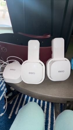 Eero router and 2 extenders with wall holders