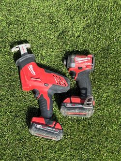 Milwaukee fuel impact driver and hacksaw with batteries