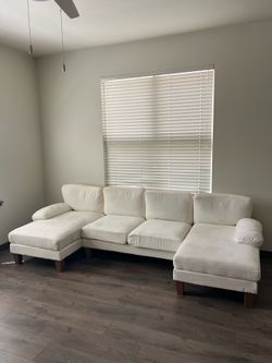 Modern cream-colored sectional sofa in excellent condition.