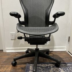 Herman Miller Aeron Classic medium Size B (two dots) executive computer office chair in standard Graphite color. Fixed armrests and no tilt recline co