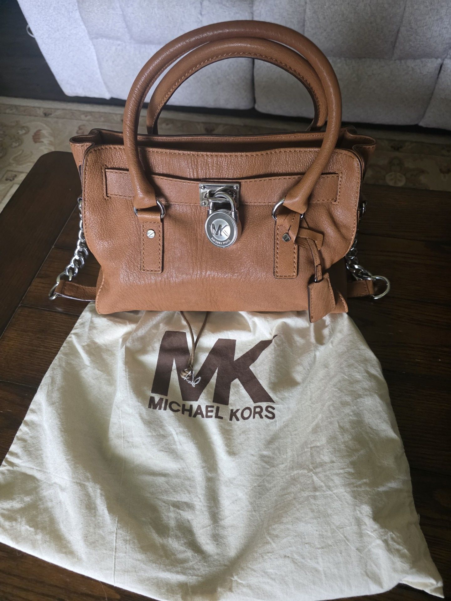 Michael Kors tan leather chain handle purse.