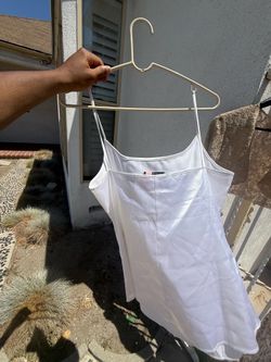 Spaghetti-strap satin cami, swing shape, layered hem.