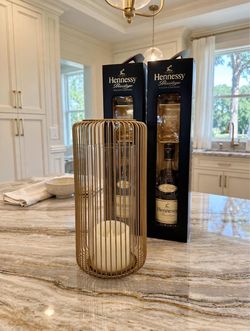 1 ft Gold metal wire + glass cage structure with an inner glass cylinder (hurricane sleeve). Included: Often holds a standard pillar or LED flameless
