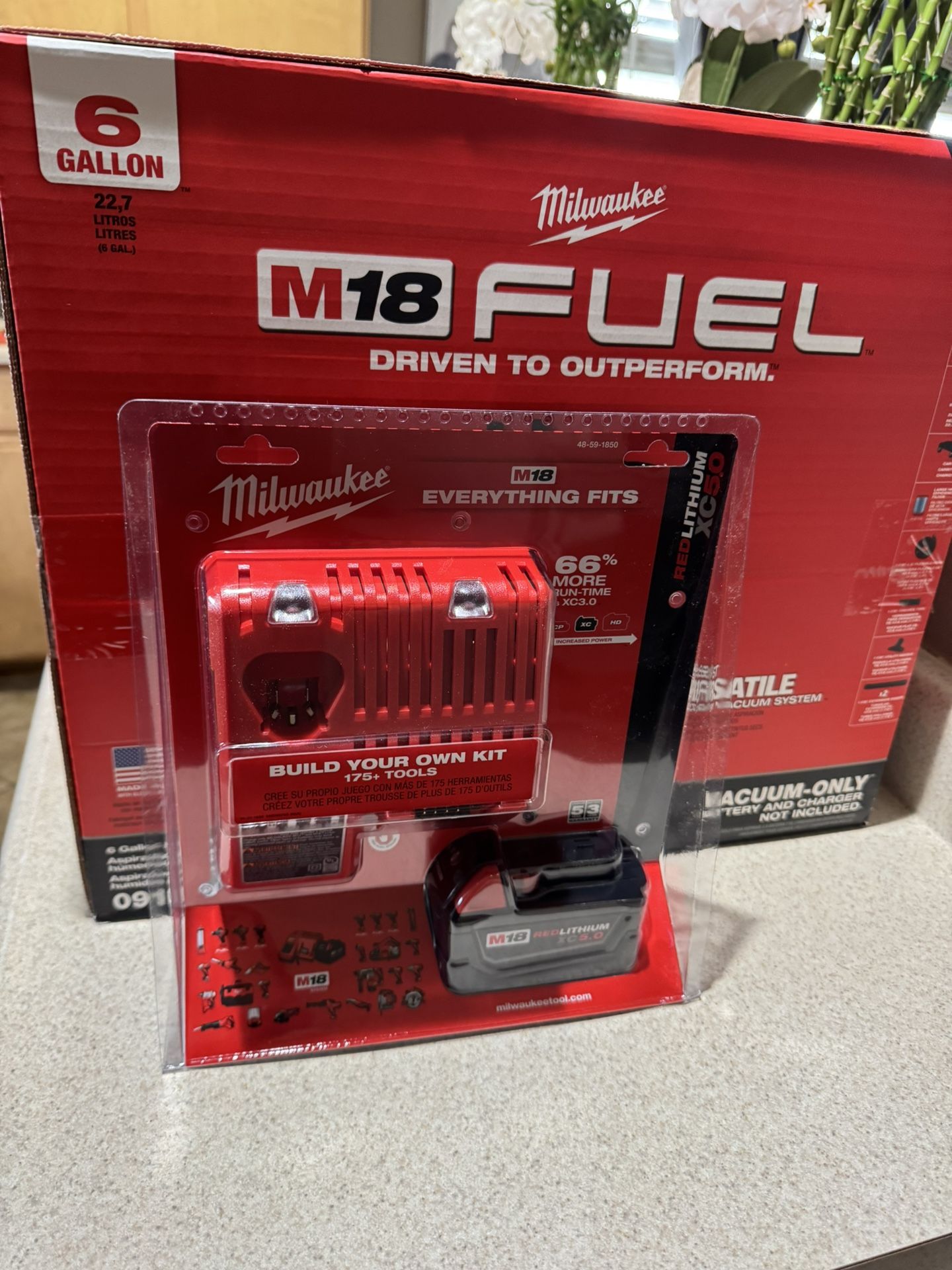 Milwaukee, vacuum and five amp battery with charger
