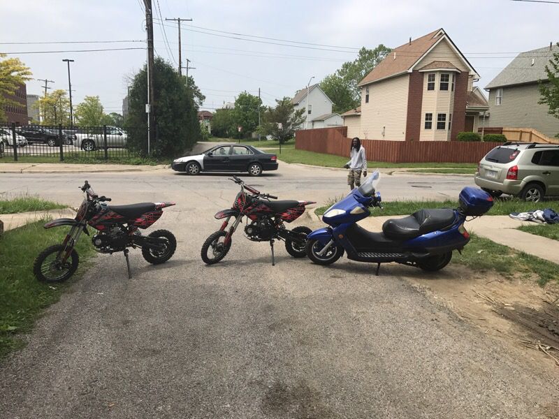 2 dirt bikes in a scooter