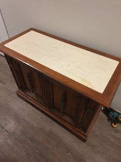 Marble and wood table with cabinets and drawer