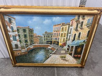 large vintage-style oil or acrylic painting on canvas depicting a classic Venetian canal and street scene, complete with an ornate gold frame.