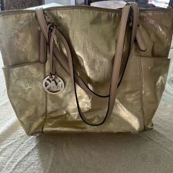 It is used, but it’s very nice Michael Kors gold purse