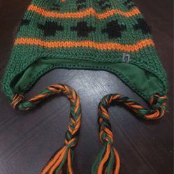 The North Face" Vintage knitted earflap hat has green, orange, and black colors
