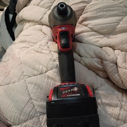 Milwaukee M18 FUEL 1/4" Hex Impact Driver with an attached M18 REDLITHIUM XC5.0 extended capacity battery pack.