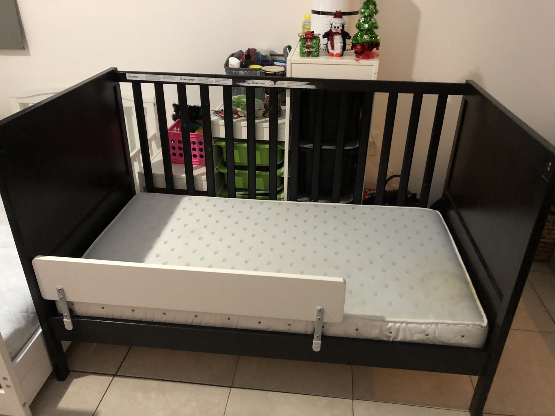 Baby Crib Converted To Toddler Bed With Side Rail And Fox Print Bedsheet