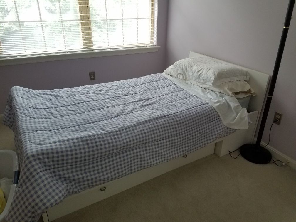 White twin bed with mattress